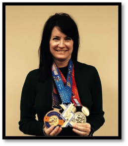 Lisa Shepherd holding her Marathon medals