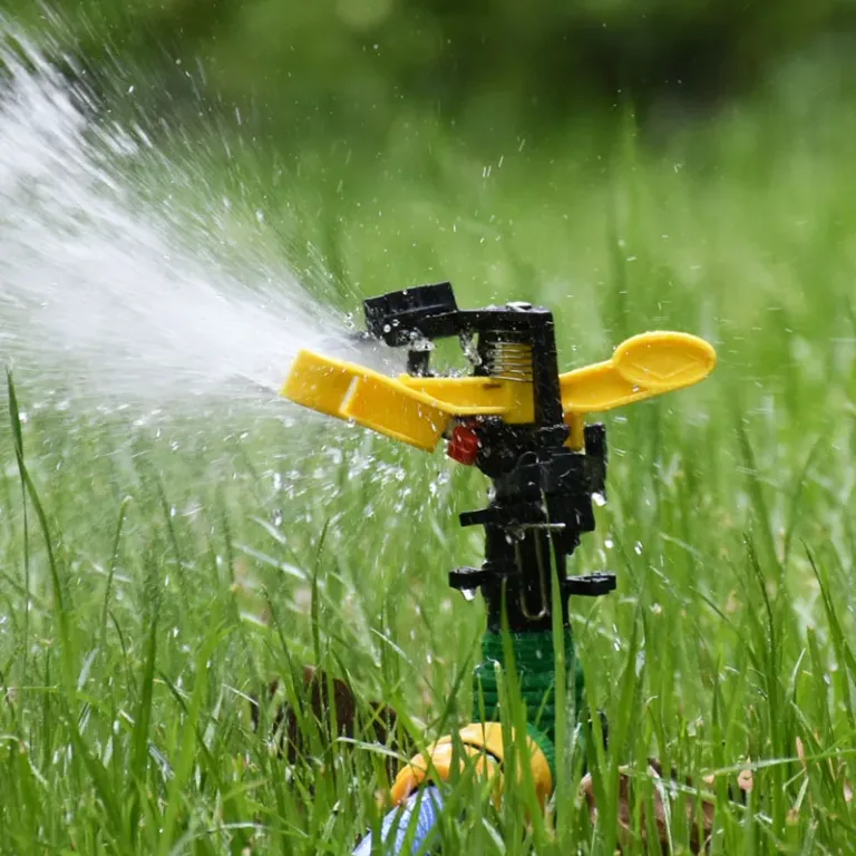 A close-up of a sprinkler head in action